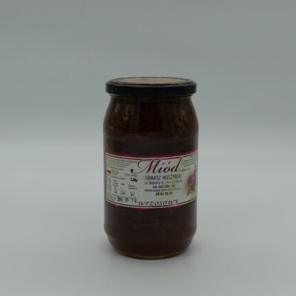 Słoik ciemnego miodu wrzosowego na naturalnym tle, podkreślający intensywny smak i bogactwo składników odżywczych